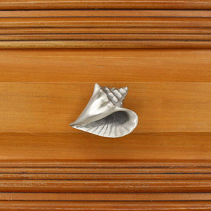 Right flange Conch shell knob on wood cabinet drawer - square view