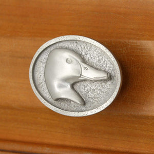 Right facing Mallard Head Knob installed on wood drawer  - close up view