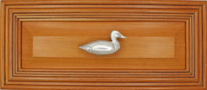 Right facing Mallard Knob installed on wood drawer - full view