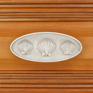 Triple Scallop Seashell Pull installed on wood drawer - square view