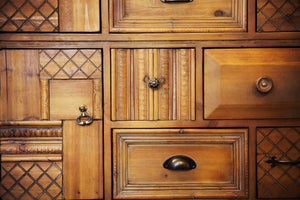 A variety of cabinet knob styles installed on furniture