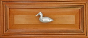 Left facing Canvasback duck knob installed on wood drawer - full view