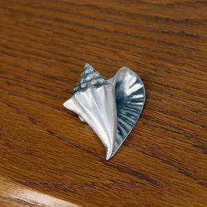 Conch shell knob on wood cabinet door