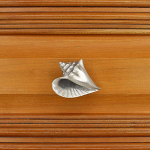 Left flange Conch shell knob on wood cabinet drawer - square view