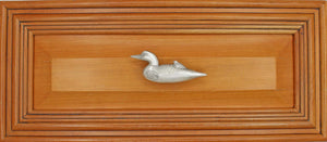 Left facing Loon knob installed on wood drawer - full view