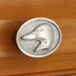 Left facing Mallard Head Knob installed on wood drawer - close up view