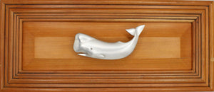 Right facing Sperm whale drawer pull on wood drawer - full view