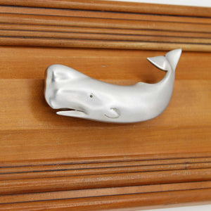 Right facing Sperm whale drawer pull on wood drawer - square view