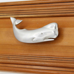 Left facing Sperm whale drawer pull on wood drawer